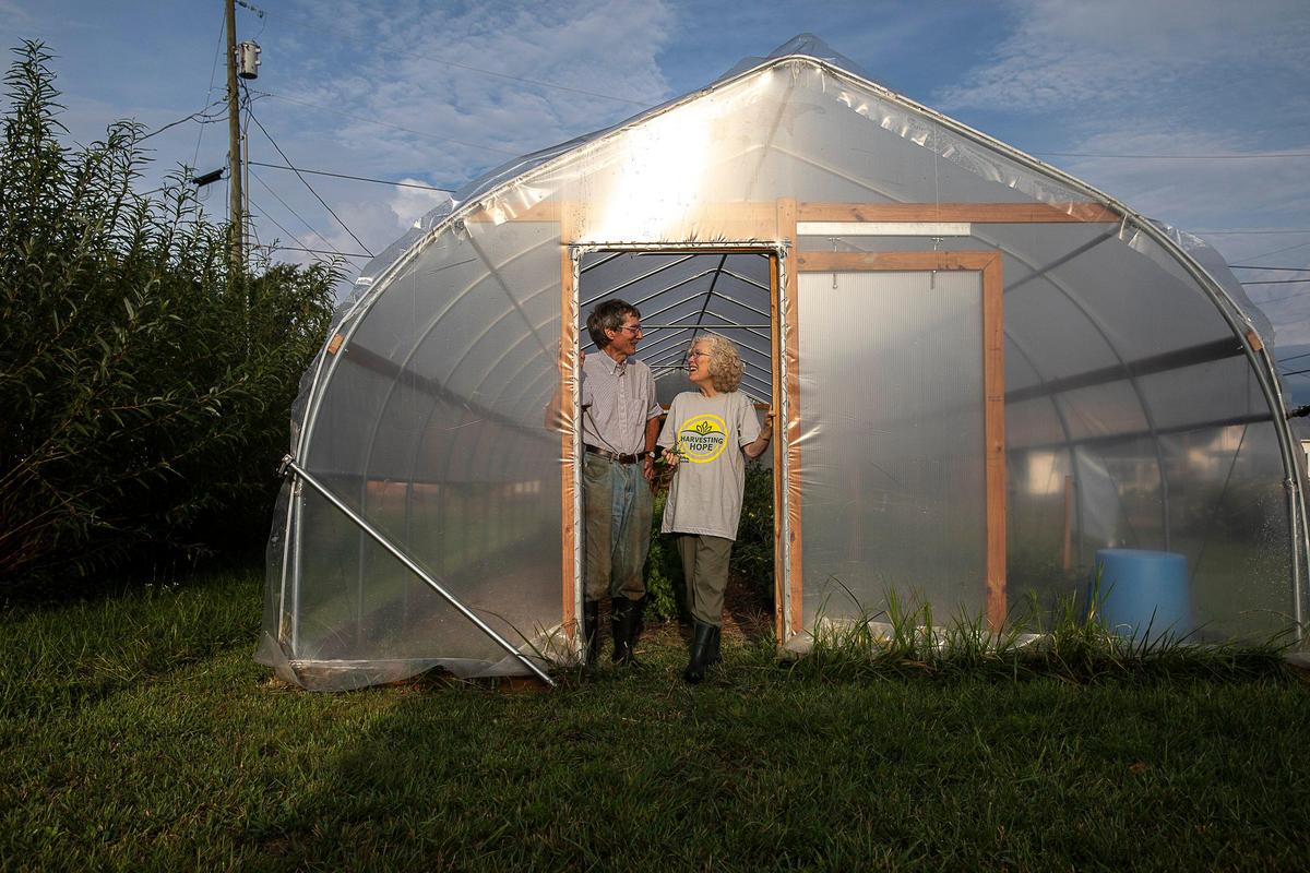 Richard and Cheyenne Olson pose for a portrait at the Berea Urban Farm in Berea, Ky., Thursday, Aug. 22, 2019.