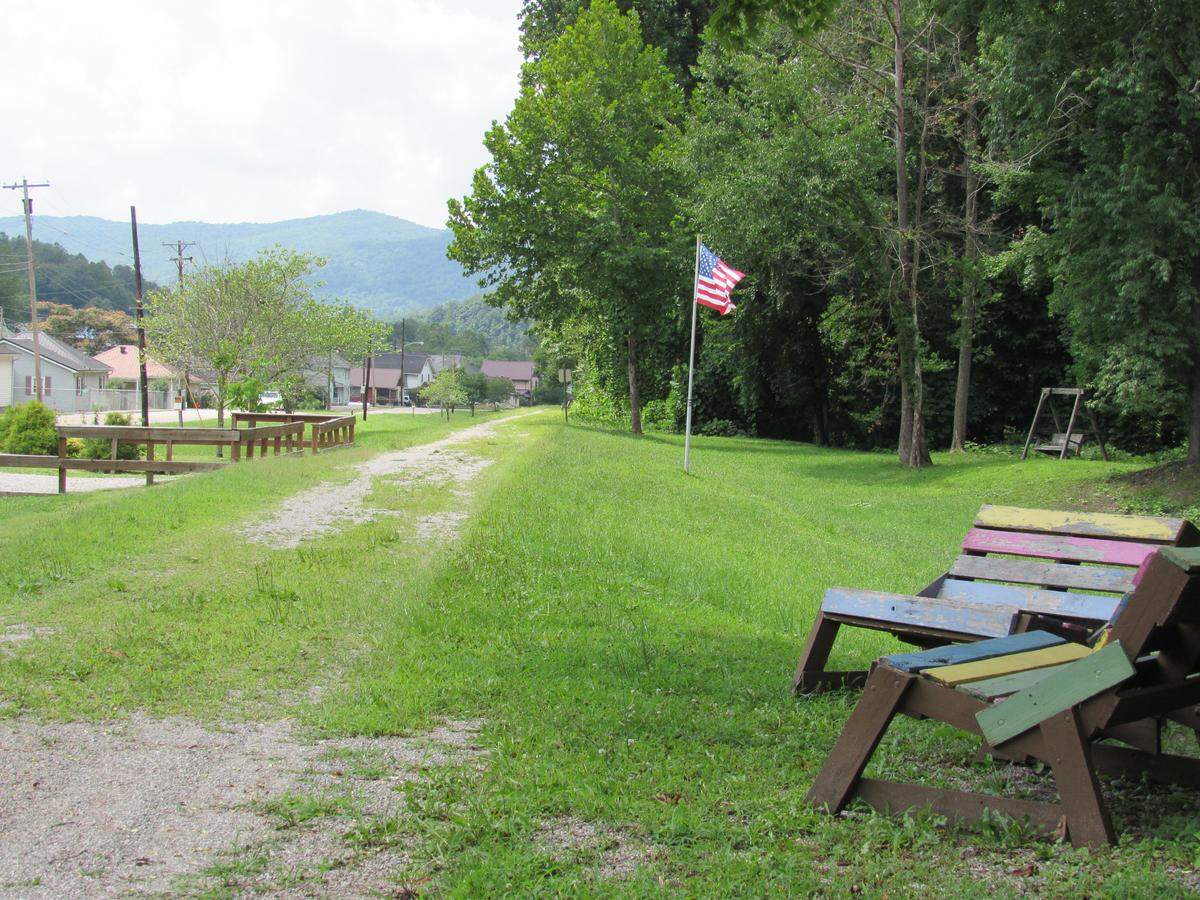 A tourism group in Harlan County received a grant to develop a railroad bed, shown here as it passes through Benham, into a trail, but the project has been on hold because the company that owns the property has not given permission to build on it.