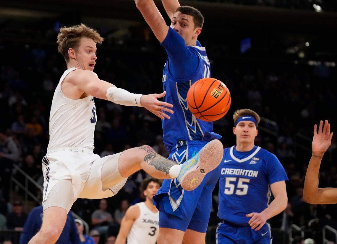 Adam Kunkel, left, makes a pass against Creighton during the Big East Tournament semifinals. He averages 10.5 points for the 13th-ranked Musketeers.