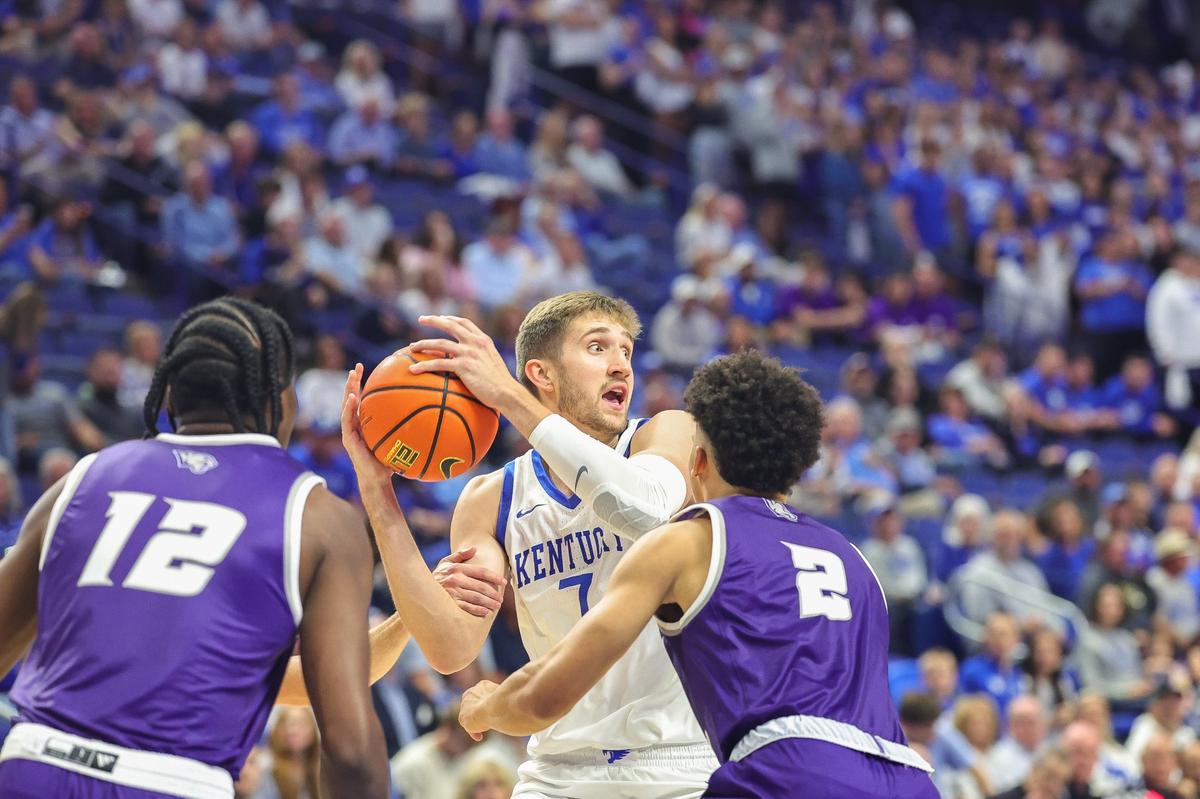 Kentucky’s Andrew Carr looks to pass out of a Kentucky Wesleyan double team during Wednesday night’s exhibition basketball opener in Rupp Arena.