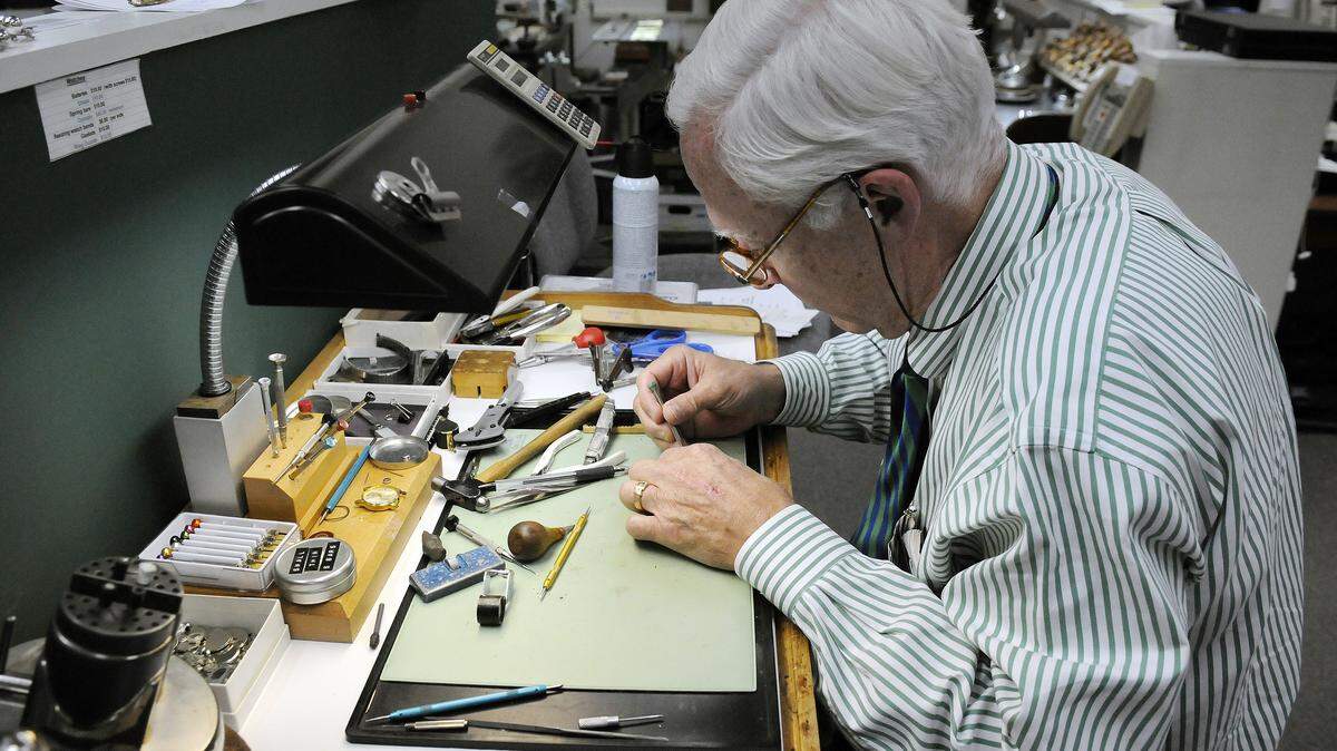 Russell Pattie, owner of Miller & Woodward jewelers, changed a watch battery for a customer at his engraving desk. Pattie said he may be the last hand-engraver in Central Kentucky.