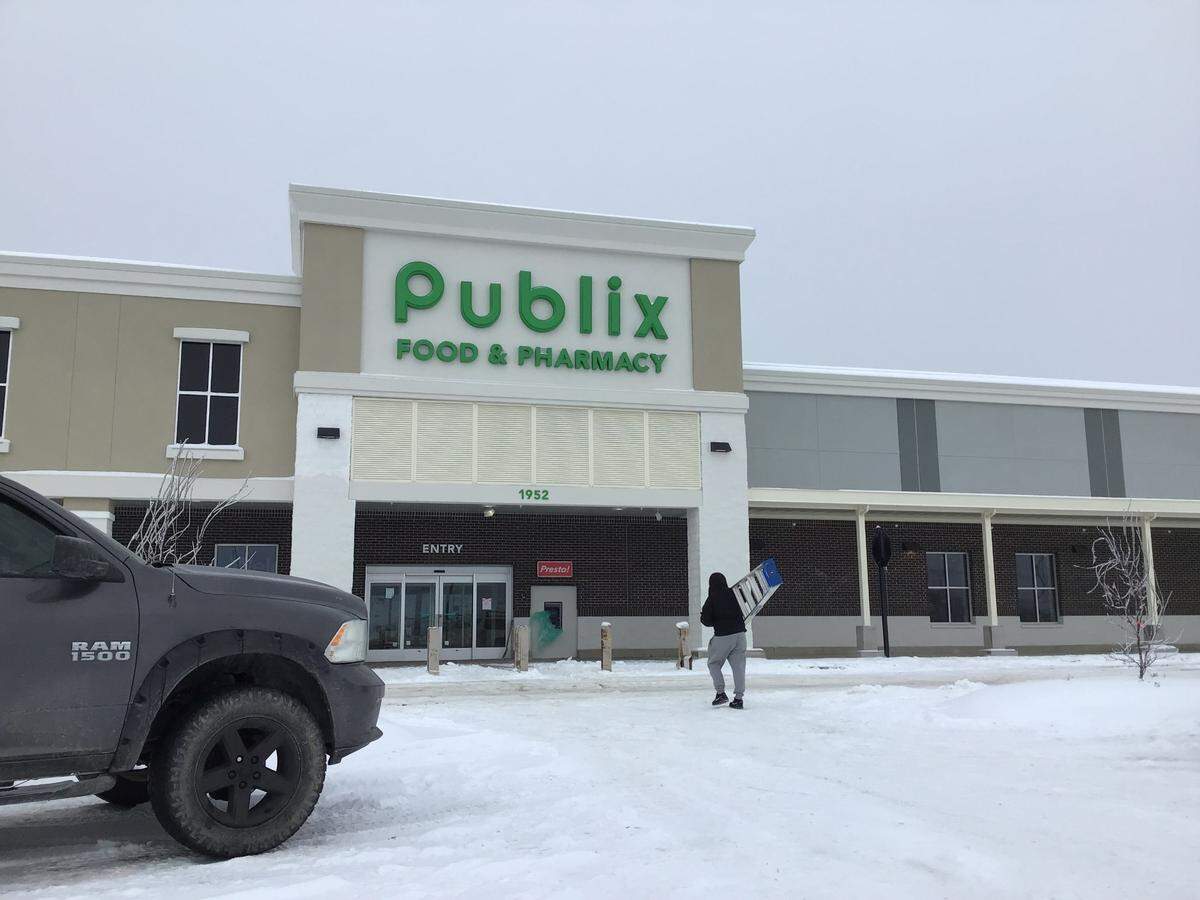 A worker carried a ladder into the new Publix grocery store building under construction at 1952 Stockton Way in Lexington, Ky., on Jan. 10, 2025. Publix will begin hiring employees over the next few weeks with a grand opening date to be announced soon.