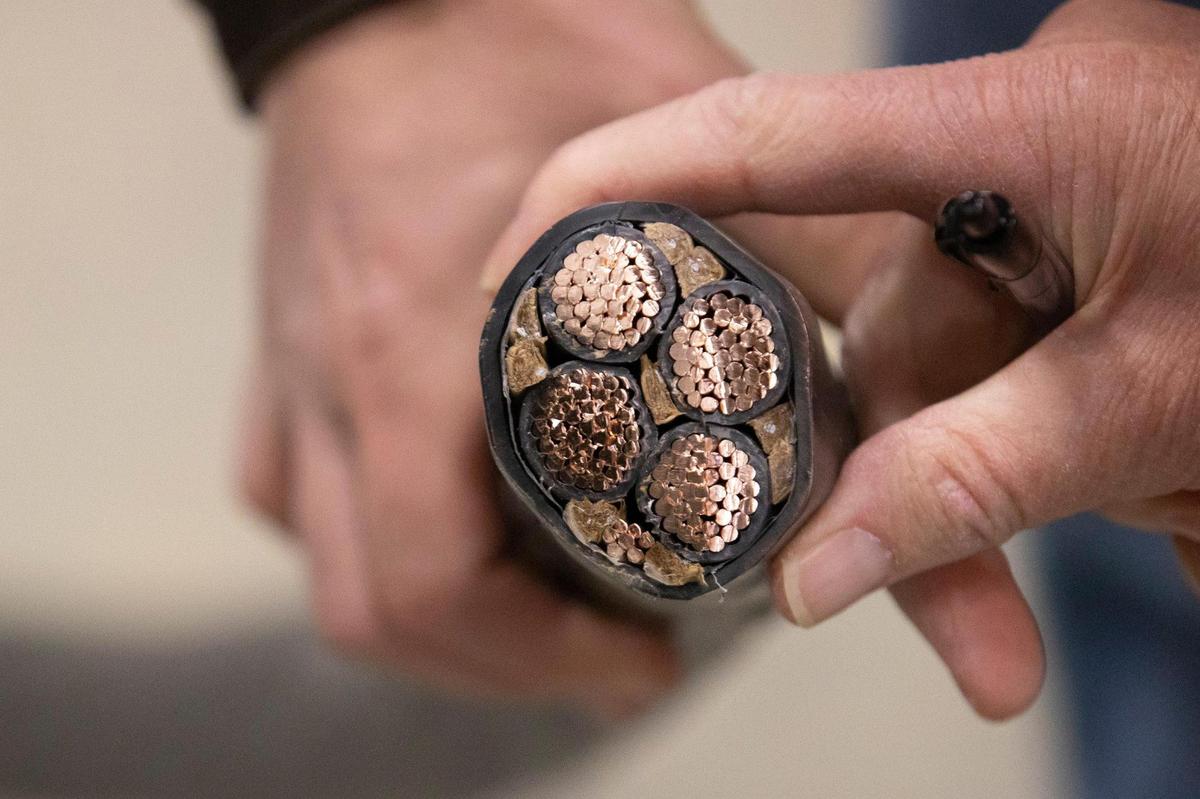 Jeremy Witten of Blockware Mining shows some of the wiring used to supply power for the company’s cryptocurrency mining facility in Paducah, Ky., on Tuesday, March 29, 2022.