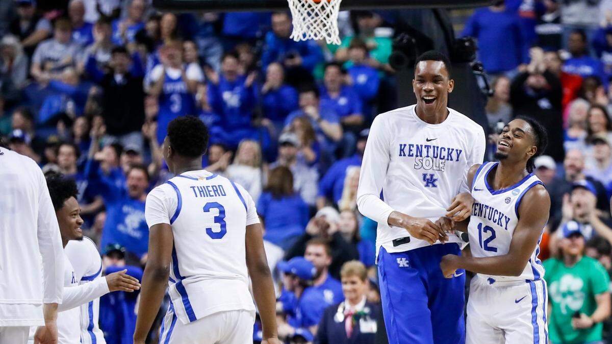 Antonio Reeves, right, celebrates with Ugonna Onyenso, center, after a basket against the Providence Friars in the first round of this year’s NCAA Tournament.