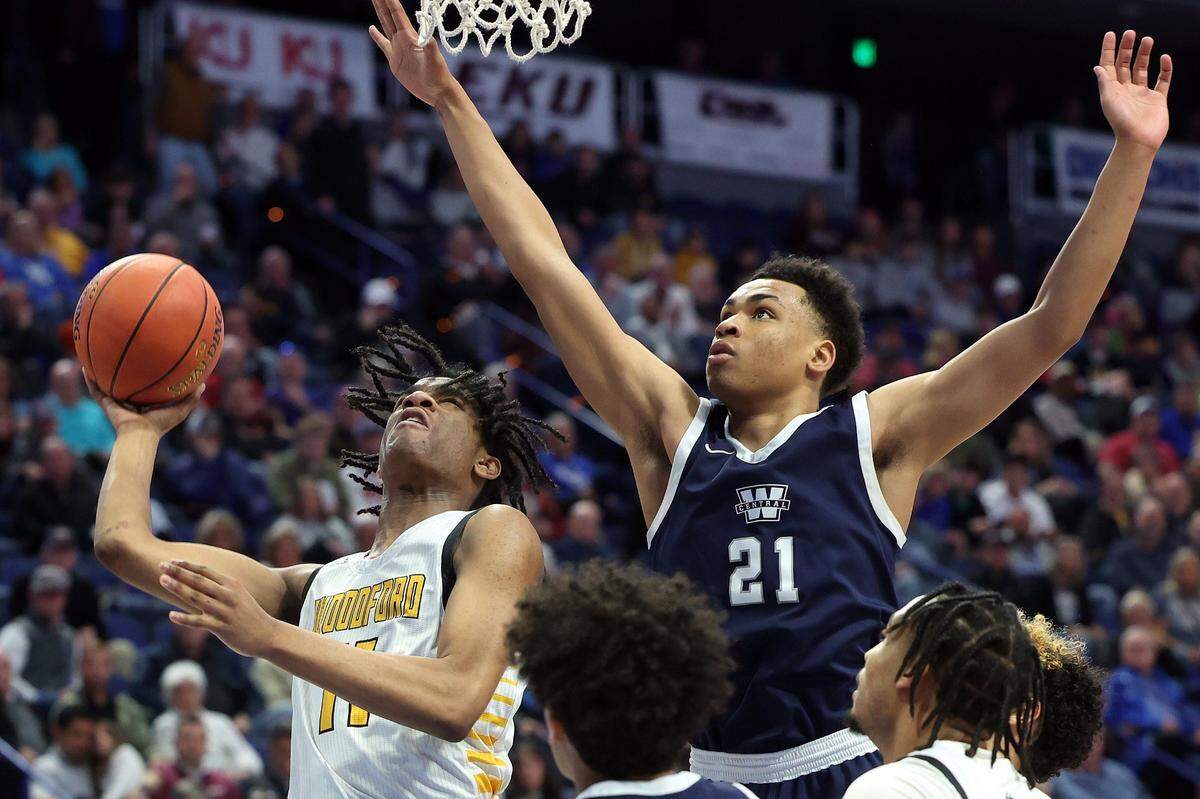 Woodford County’s Layton Starks (11) shoots while defended by Warren Central’s Chappelle Whitney (21) during Saturday’s Sweet 16 semifinals at Rupp Arena.