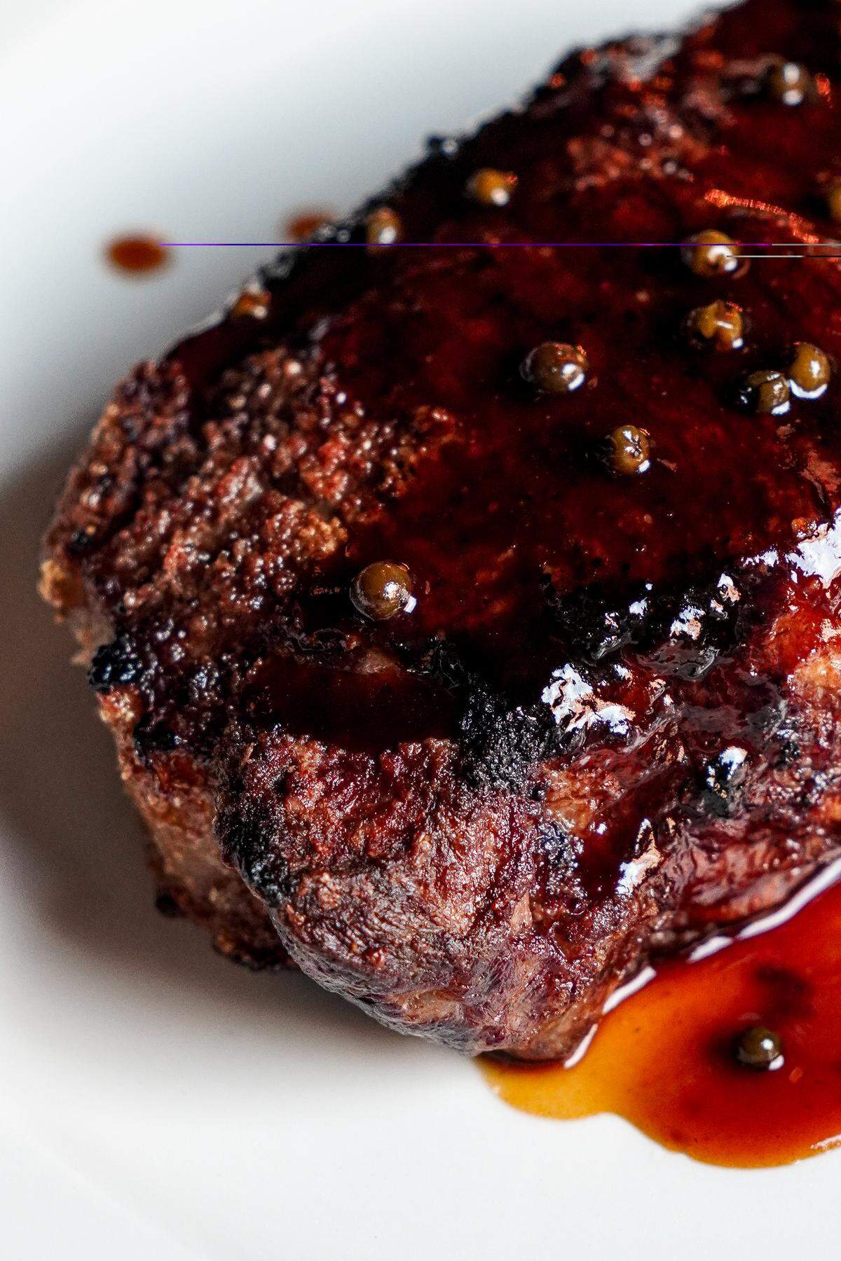 A 16 oz. New York strip steak ($70) topped with green peppercorn bordelaise sauce ($5) at Silk’s Steakhouse located inside The Aldenberg Hotel in Versailles, Ky.