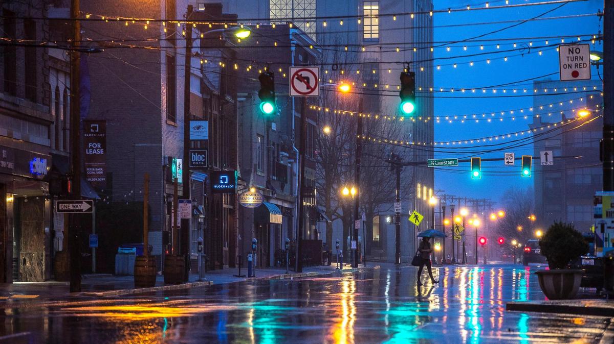 A pedestrian crosses Short Street in downtown Lexington during a rain shower Thursday, March 18, 2021. The wet weather is expected through at least Friday this week.