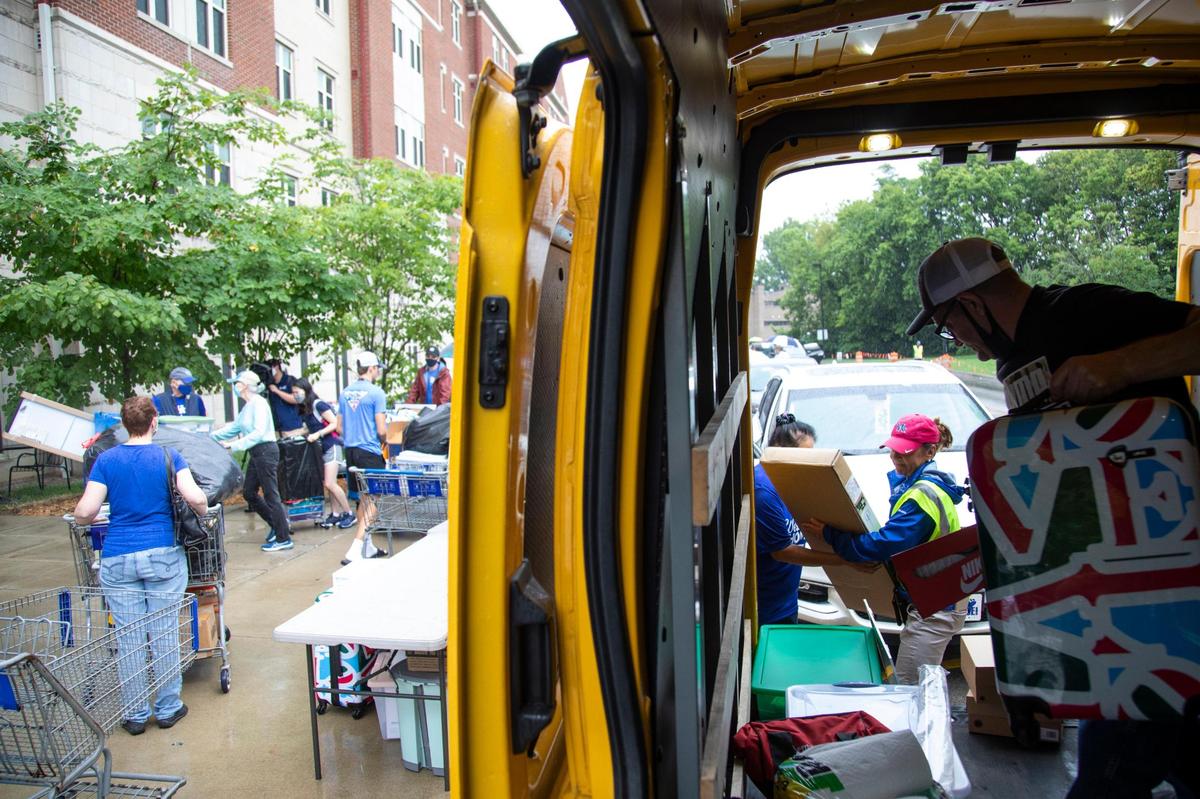 Ron Pannebaker, of Illinois, unloads a van with his granddaughters belongings outside Woodland Glen III residence hall Monday on move-in day at UK.