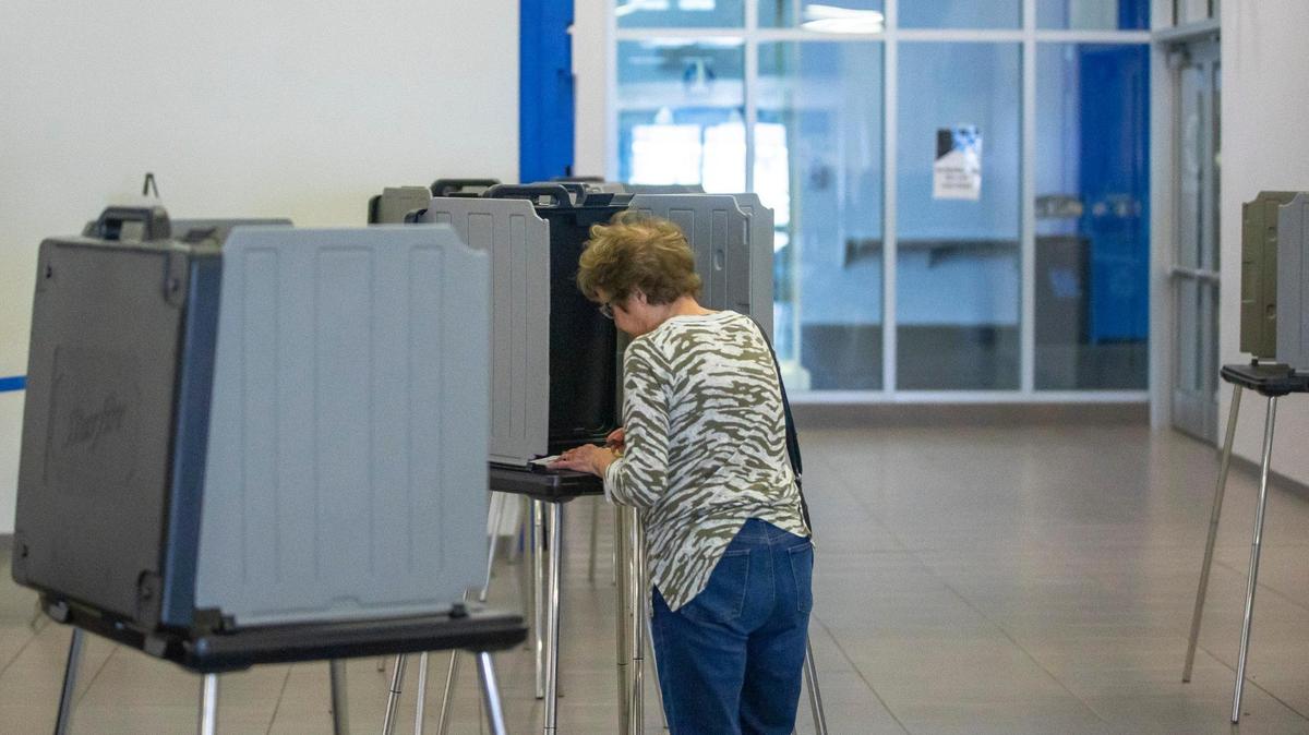 A voter casts their ballot during early voting at Kroger Field in Lexington, Ky., on Thursday, May 12, 2022.