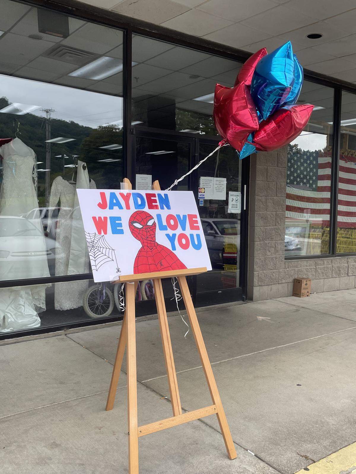 Businesses throughout Jackson, KY, posted signs for Jayden, alongside blue and red balloons.