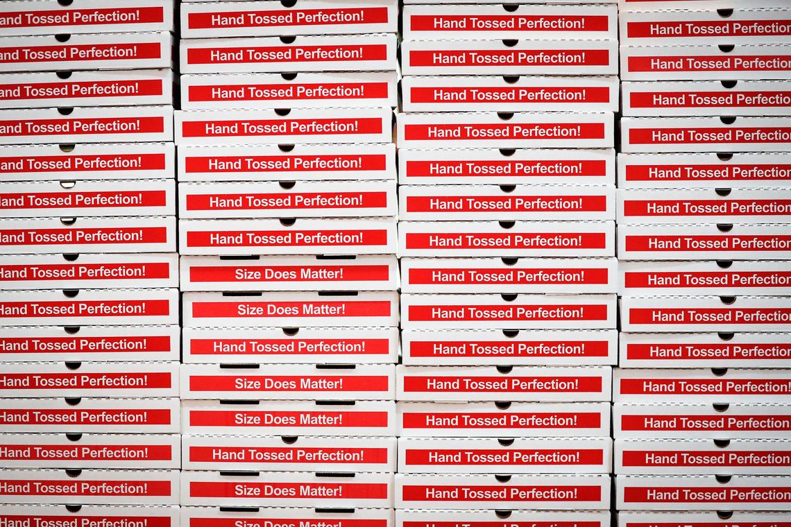 Stacks of pizza boxes sit at Goodfellas Pizzeria in the Distillery District.