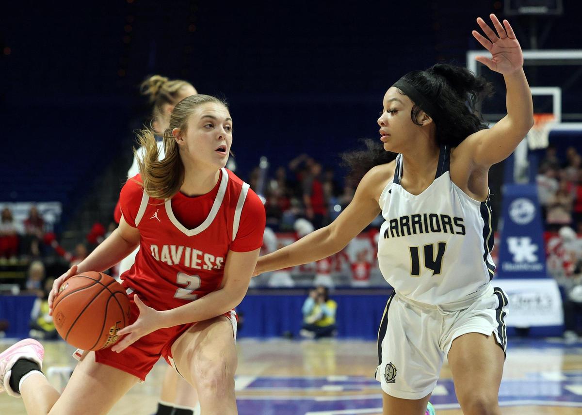 Danville Christian’s Alaya Quisenberry (14) defends Daviess County’s Lily Hoagland (2) during their first-round game Thursday. Quisenberry finished with 17 points.