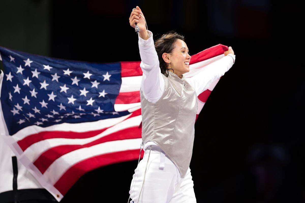 Paul Laurence Dunbar High school alumna and University of Kentucky medical school student Lee Kiefer celebrates after winning gold in an all-American women’s foil fencing finals at the 2024 Olympics in Paris on Sunday. It was the second straight Olympics gold medal won by Kiefer in the event.