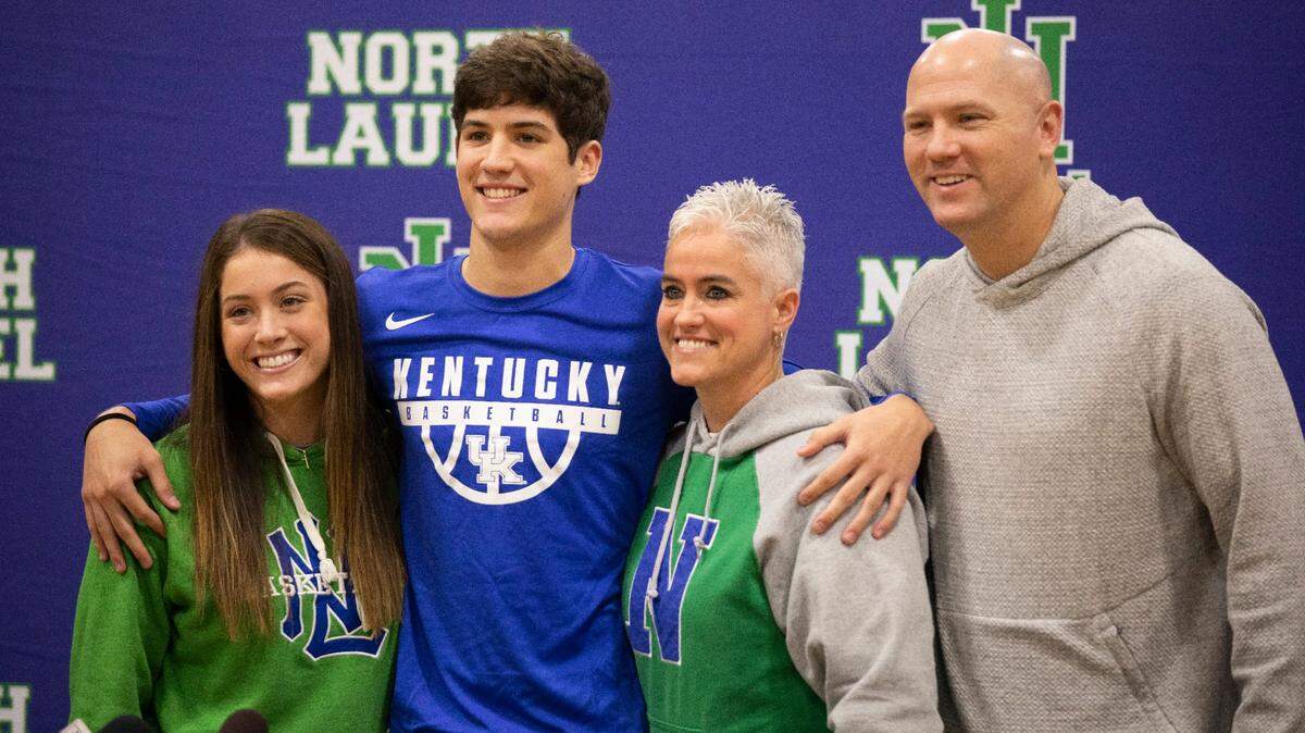 North Laurel High School basketball star Reed Sheppard poses for a photo with his family after announcing his decision to play for Kentucky basketball this morning at North Laurel High School in London, Ky., Saturday, November 20, 2021. He is the son of former UK basketball players Jeff Sheppard and Stacey Reed Sheppard.