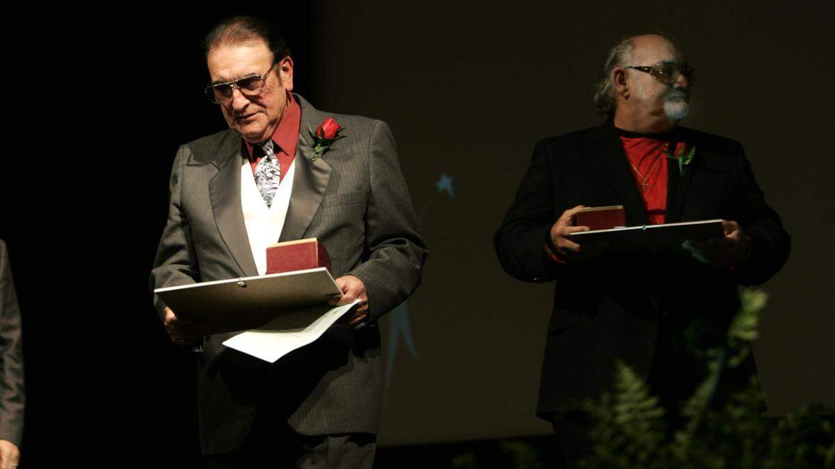 Bobby Osborne, left, and his brother Sonny, who recorded their most popular tune, “Rocky Top,” in 1967, leave the stage after receiving their Kentucky Stars at The 2004 Kentucky Stars recognition ceremony at the Kentucky Theatre on October 26, 2004.