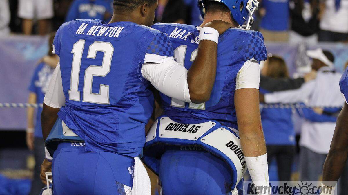 Kentucky Wildcats quarterback Maxwell Smith (11) was consoled by Kentucky Wildcats quarterback Morgan Newton (12) as they left the field as Western Kentucky University defeated Kentucky 32-31   on Saturday September 15, 2012 in Lexington, Ky. Photo by Mark Cornelison | Staff