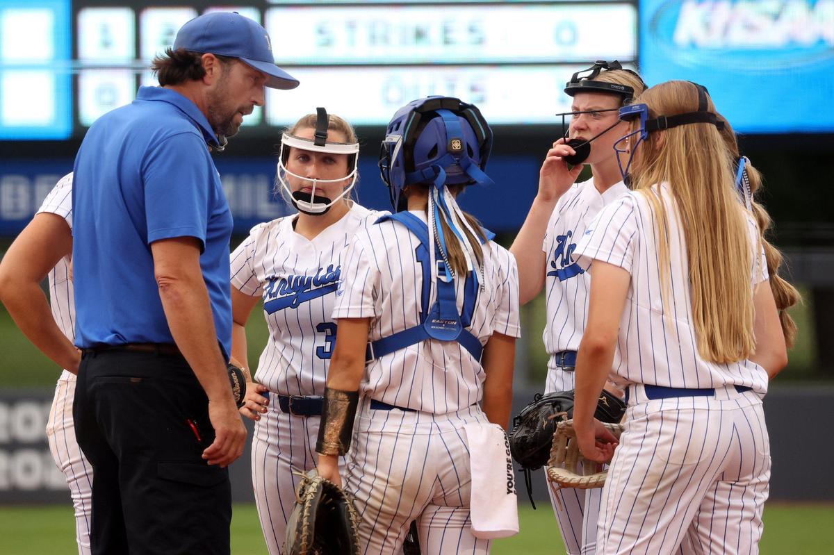 Lexington Catholic head coach Emery Emmert, left, speaks with his players in the circle during their quarterfinal game against South Warren in the Clark’s Pump-N-Shop Softball State Tournament at John Cropp Stadium on Saturday.