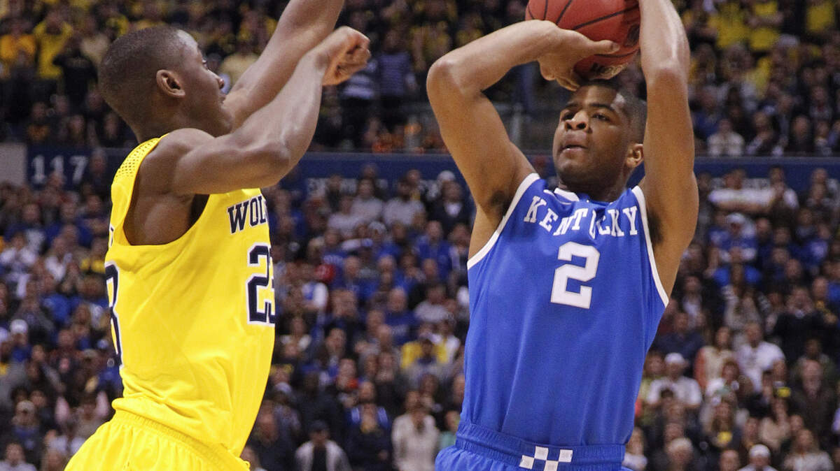 Aaron Harrison prepares to launch the game-winning three-pointer in the game against Michigan that won Kentucky a trip to the Final Four. Photo by Mark Cornelison | Staff