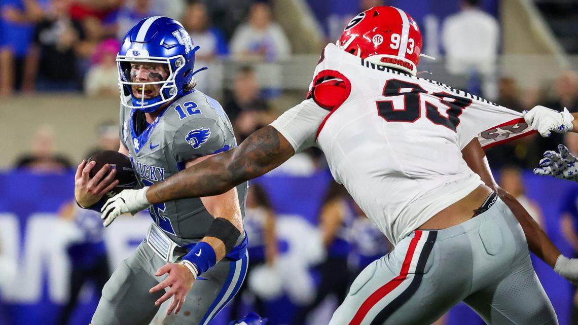 Kentucky quarterback Brock Vandagriff (12) tries to run past Georgia defensive lineman Tyrion Ingram-Dawkins (93) during Saturday’s game against Georgia.