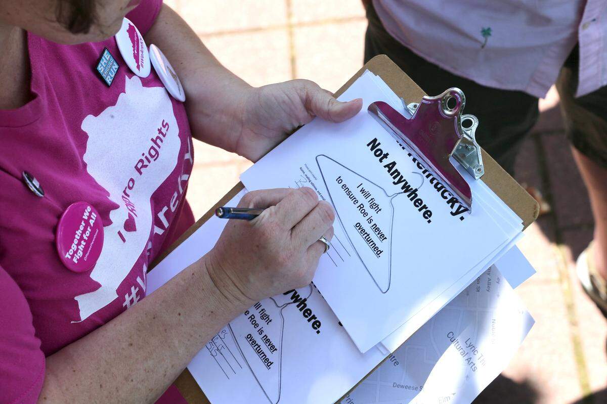 A woman signed a petition supporting abortion rights May 25, 2019, during the Convergence for Reproductive Rights, sponsored by Kentucky NOW, at Courthouse Plaza in Lexington.