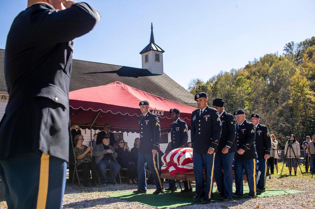 Members of the honor guard place the casket of Army Pfc. Berton J. McQueen before the family during a funeral at the Wind Cave Baptist Church in Jackson County outside McKee, Ky., Saturday, October 16, 2021. McQueen died in France in 1944 during World War II and his body was not identified until July 2021, 76 years later.