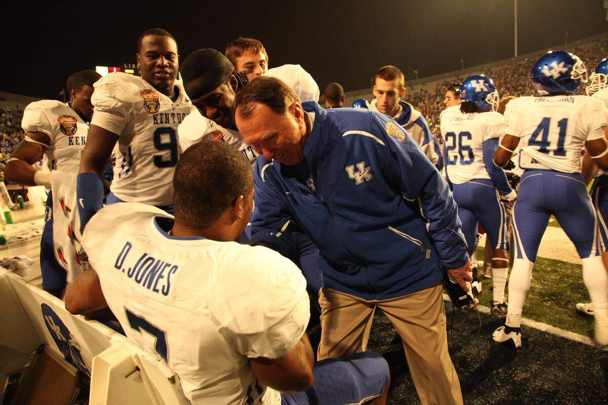 Then-UK Coach Rich Brooks congratulated David Jones after Jones returned the opening kickoff of the second half 99 yards for a touchdown against East Carolina in the post-2008 season Liberty Bowl. The play ignited Kentucky from a 16-3 halftime deficit to a 25-19 victory.