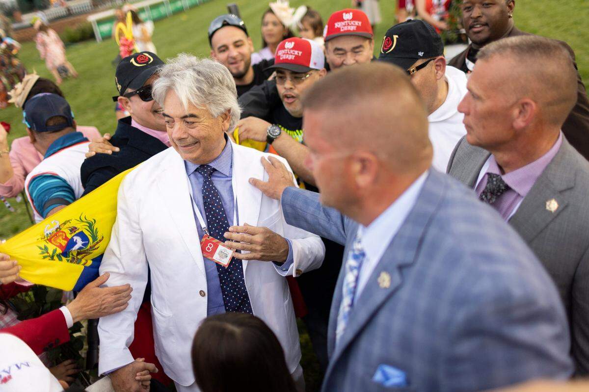 Trainer Gustavo Delgado is congratulated by his connections after Mage won the Kentucky Derby. Delgado earned his first Derby win in his third try.
