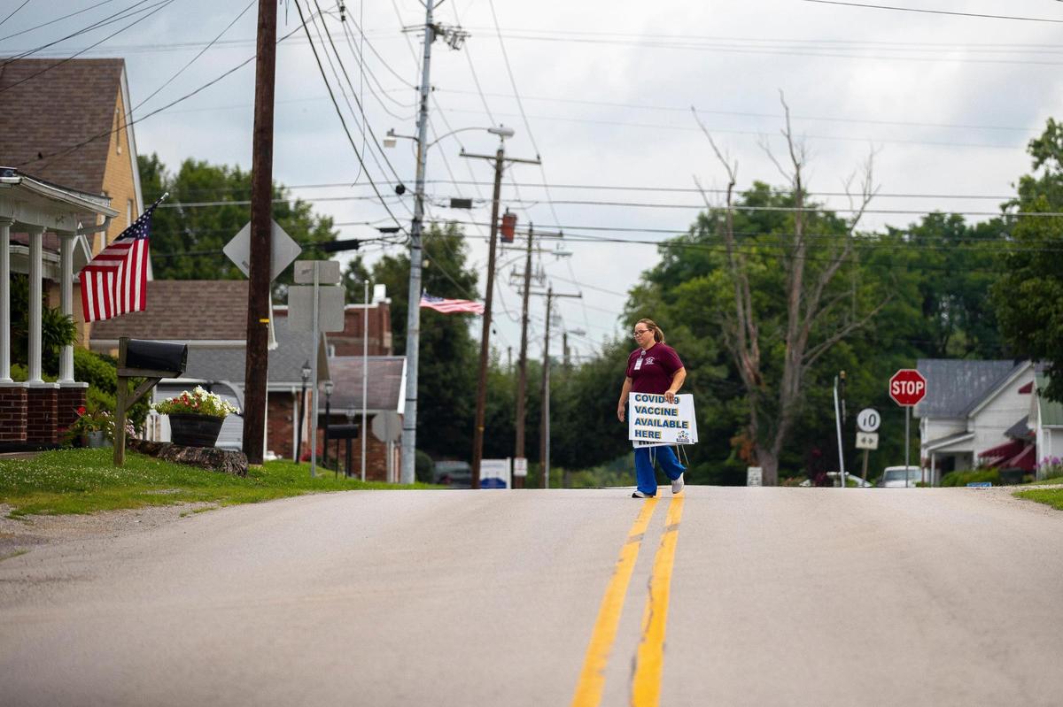 Linda Stahl, Buffalo District Health Department clinic nurse, collects signs after a COVID-19 vaccine clinic at the Germantown, Ky., community center and volunteer fire department on Wednesday, July 14, 2021. During the 2-hour pop-up clinic, no one came seeking a vaccine.