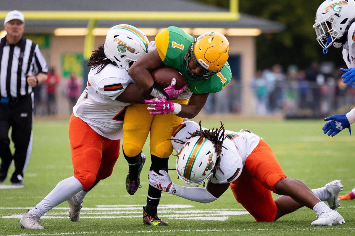 Bryan Station running back Kalen Washington (1) is tackled by a pair of Broncos during their game against Frederick Douglass this season. Both teams are poised to make deep runs in the Class 6A playoffs.