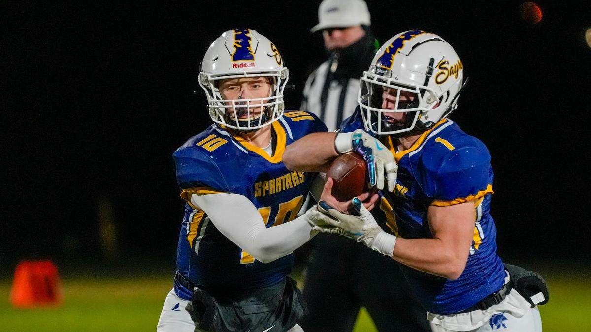 Sayre quarterback Luke Pennington (10) hands off to Charlie Slabaugh during Friday night’s win.