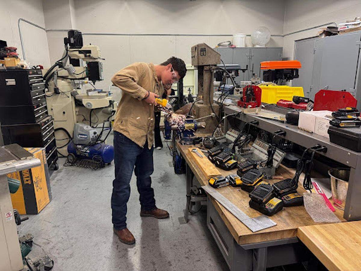 A key component of Robot Gladiator League is learning and using skills that students can use out of the classroom. A Craft Academy student is shown using a metal grinder as he prepares the weapons on his robot.