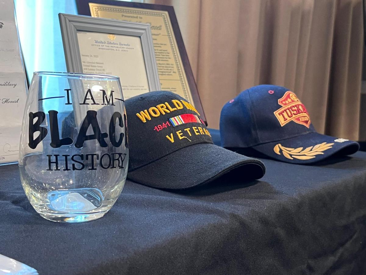 “I am Black History” cup along side WWII veterans and Tuskegee Airman military cover of WWII veteran Glendell Bennett’s 100th birthday celebration on Saturday, March 2, 2024. At the Embassy Suites by Hilton Lexington Green, Lexington, Ky.