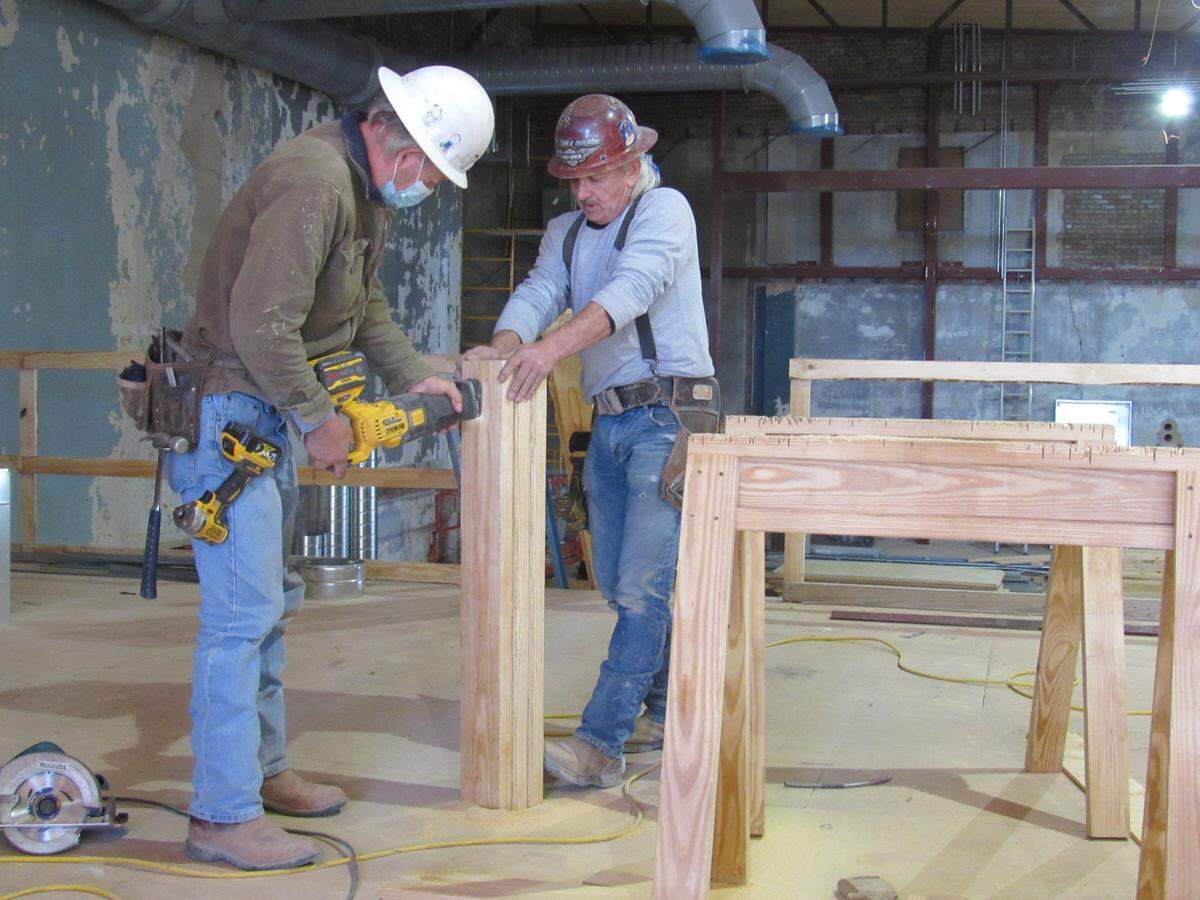 Doug Baker, left, and Scott York of D.W. Wilburn Inc. work on a door header Dec. 9, 2021 during the renovation of the Virginia Theater in downtown Somerset.