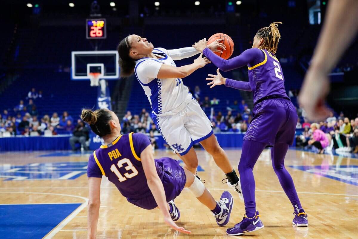Kentucky guard Jada Walker, center, fouls LSU guard Last-Tear Poa (13) while trying to get to the basket during Sunday’s game at Rupp Arena. Walker scored four points for the Wildcats.