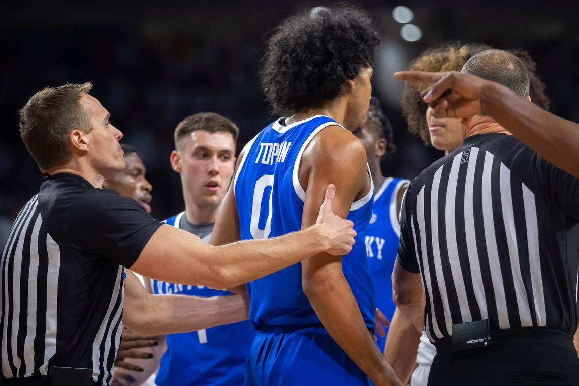 A referee holds back Kentucky forward Jacob Toppin (0) during Saturday’s game against Arkansas at Bud Walton Arena in Fayetteville, Ark.