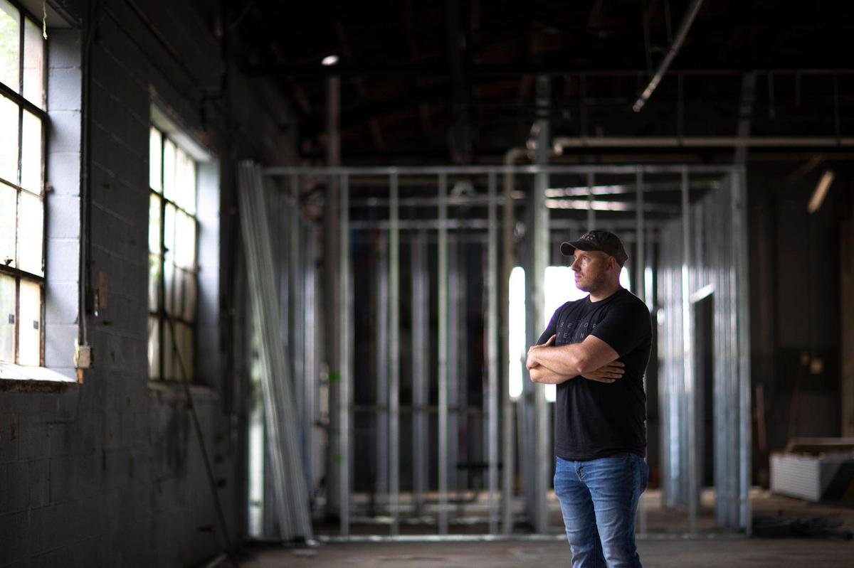 Abettor Brewing owner Tyler Montgomery poses for a portrait at the brewery’s second location, under renovation, at 136 N. Highland St. in Winchester, on Monday, June 7. The expansion will feature a beefed up brewing system and a larger emphasis on live music with indoor and outdoor stages.