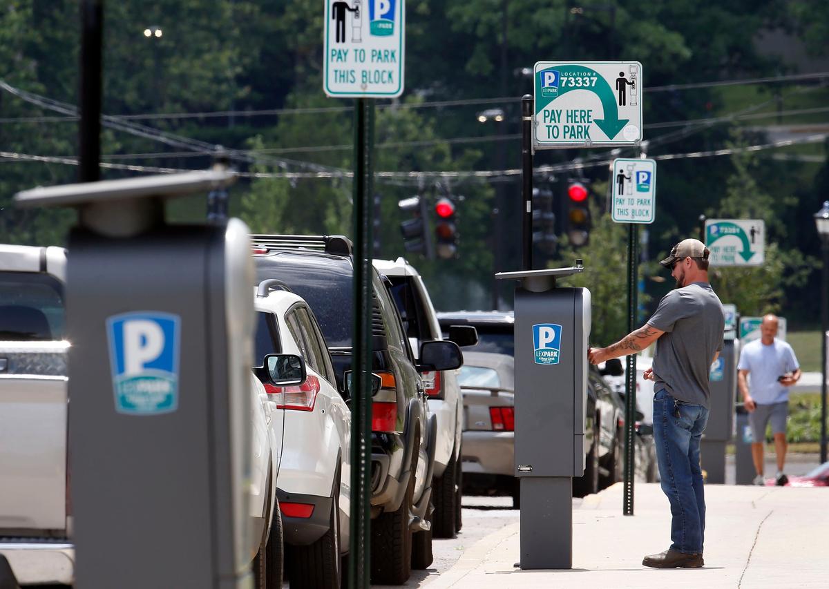 Jeremie Mitchell paid to park Tuesday afternoon on Lexington Avenue between Maxwell Street and Avenue of Champions. Lexpark says it will lose $200,000 in revenue from parking meters on streets the city will give to the University of Kentucky as part of a swap that involves streets for land for economic development.