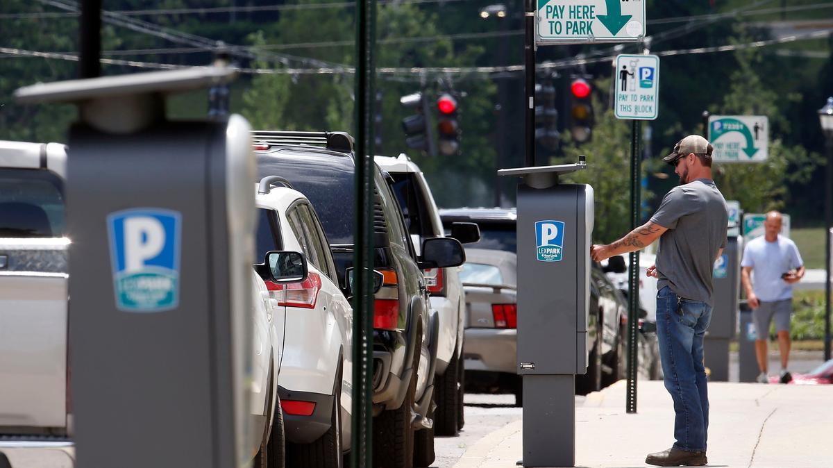 Jeremie Mitchell pays to park on Lexington Avenue between Maxwell Street and Avenue of Champions.