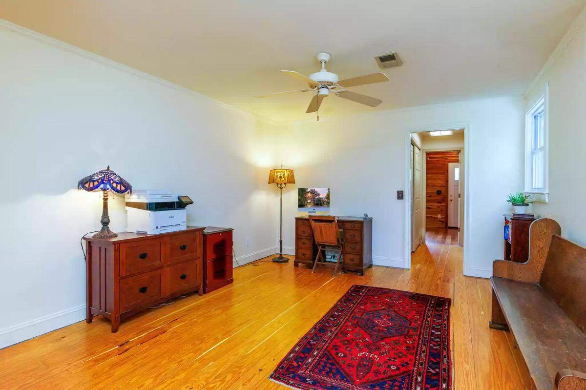 A mostly empty spare room that connects to the upstairs bedroom at 4351 Bethel Road. 