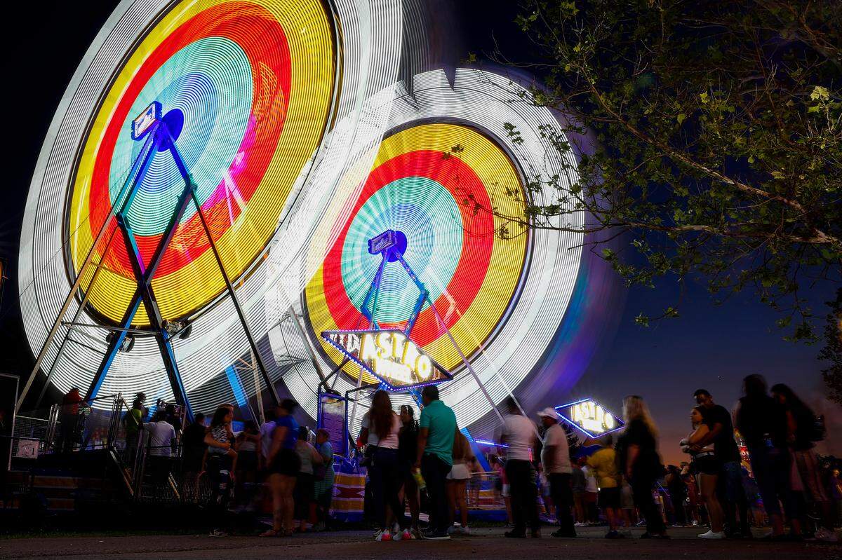 Fairgoers line up for the Astro Wheel at the Lexington Lions Club Bluegrass Fair at Masterson Station Park in Lexington, Ky., Tuesday, June 15, 2021.