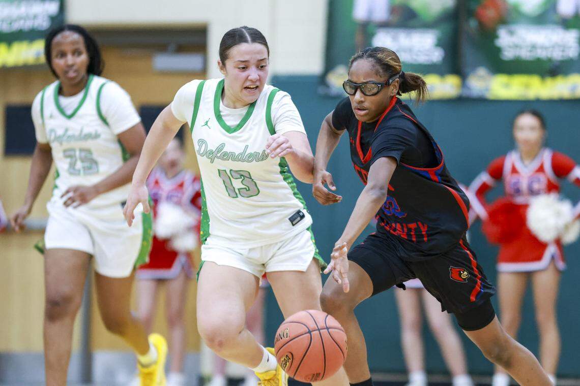 Scott County's Kiley Sweeting, right, dribbles past Bryan Station's Sofia Haggard during the girls 42 District Tournament Semifinal at Bryan Station High School in Lexington, Kentucky, on Wednesday, Feb. 25, 2026.