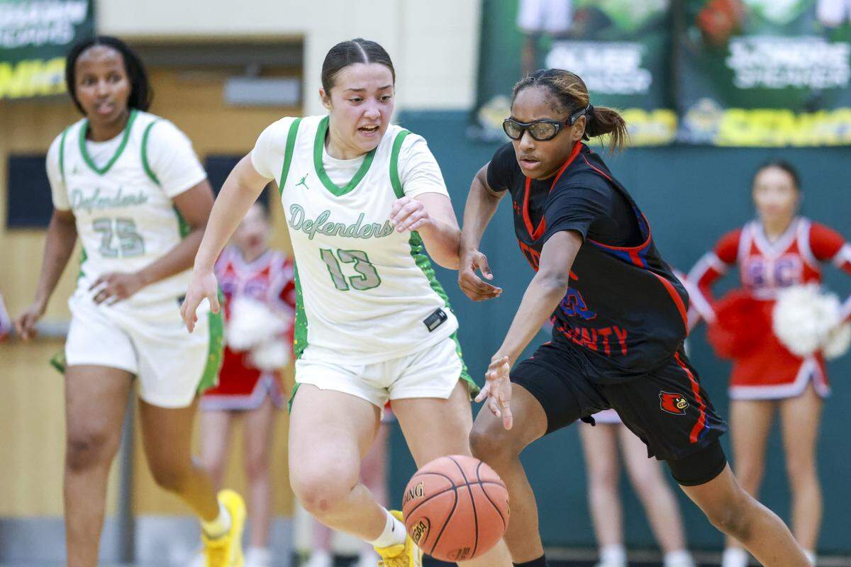 Scott County's Kiley Sweeting, right, dribbles past Bryan Station's Sofia Haggard during the girls 42 District Tournament Semifinal at Bryan Station High School in Lexington, Kentucky, on Wednesday, Feb. 25, 2026.