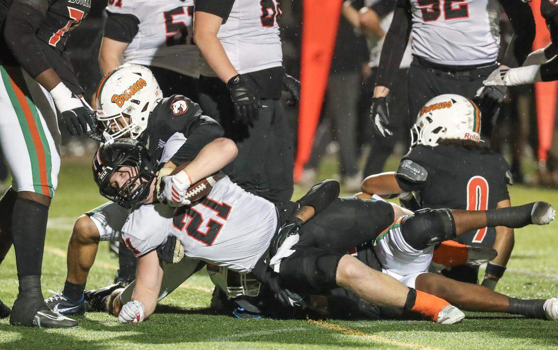 Ryle'sGreyson Hawkins was tackled by several Broncos in the second quarter of the Ryle at Douglass high school Class 6A Region Championship football game at Frederick Douglass High School in Lexington, KY on Nov. 212025. Photo by Pablo Alcala