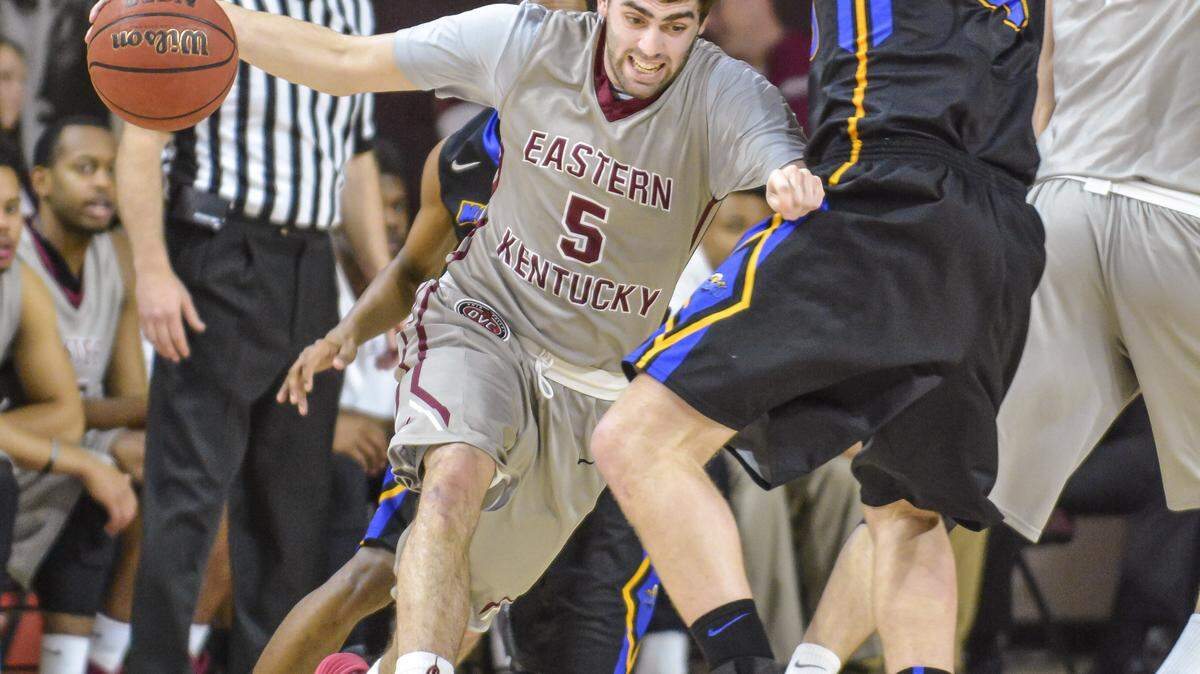 Eastern's Isaac McGlone drives past Morehead's Billy Reader, Wednesday night, February 11, 2015, at McBrayer Arena in Richmond.
Photo by Tim Webb  