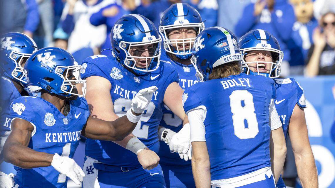 Kentucky quarterback Cutter Boley (8) celebrates with his teammates after his 30-yard rushing touchdown against Tennessee Tech on Saturday at Kroger Field.