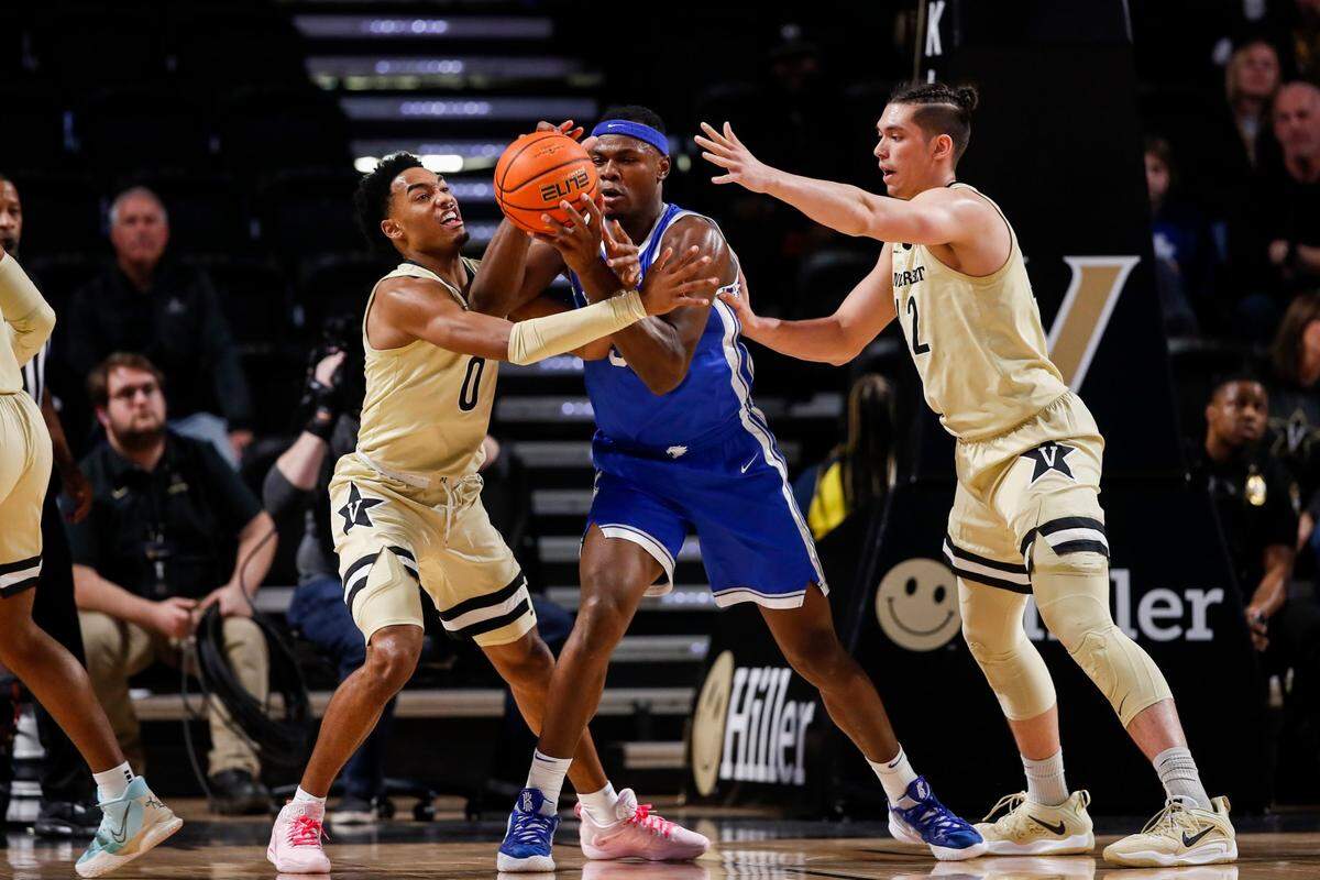 Kentucky Wildcats forward Oscar Tshiebwe (34) fights for control of the ball with Vanderbilt Commodores guard Tyrin Lawrence (0) and Vanderbilt Commodores forward Quentin Millora-Brown (42) during the game at Memorial Gymnasium in Nashville, Tn., Tuesday, January 24, 2023.