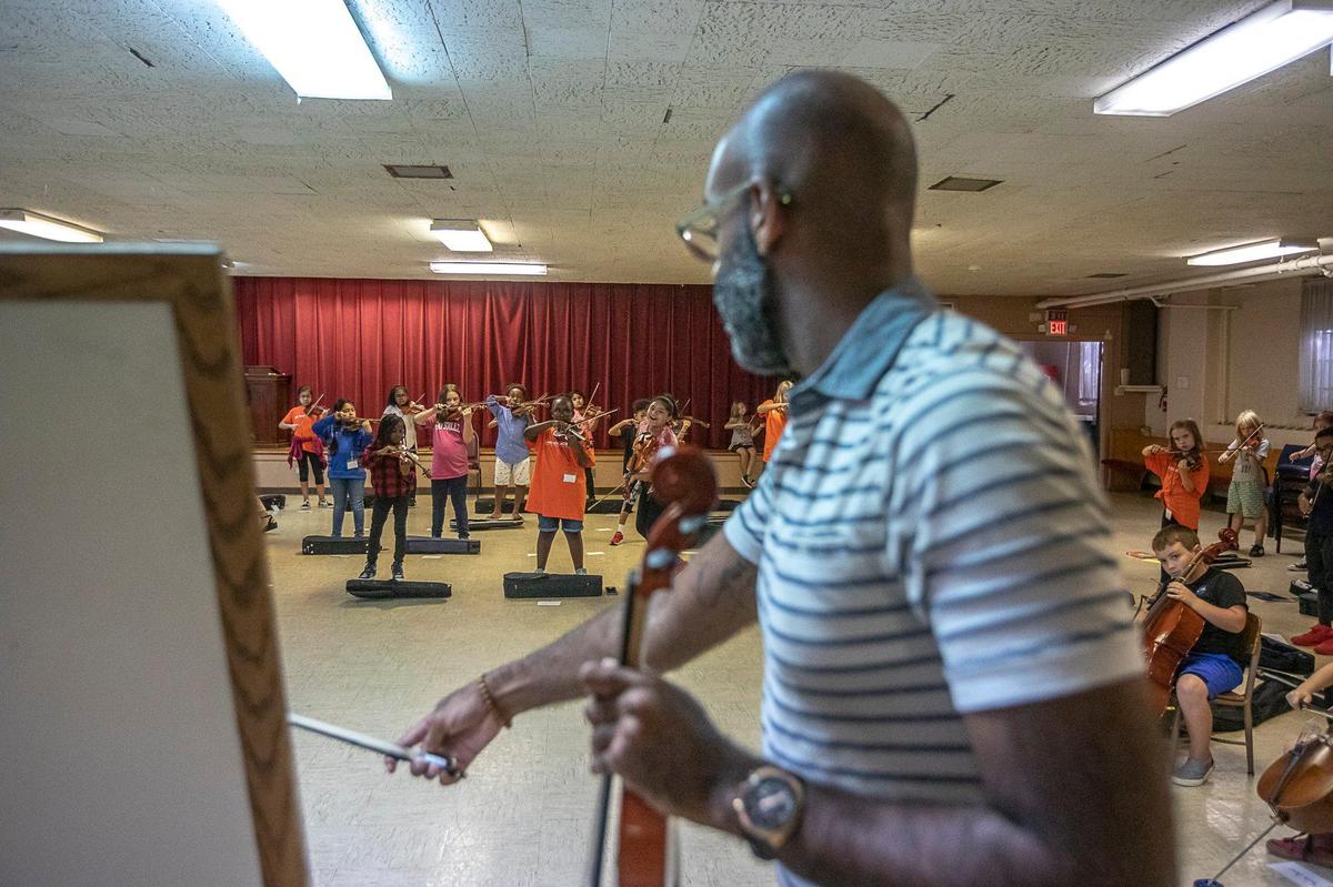 MusicWorks program director Chase Miller leads a class Tuesday at Lexington’s Arlington Christian Church. The music program brings high level music instruction to low-income kids.