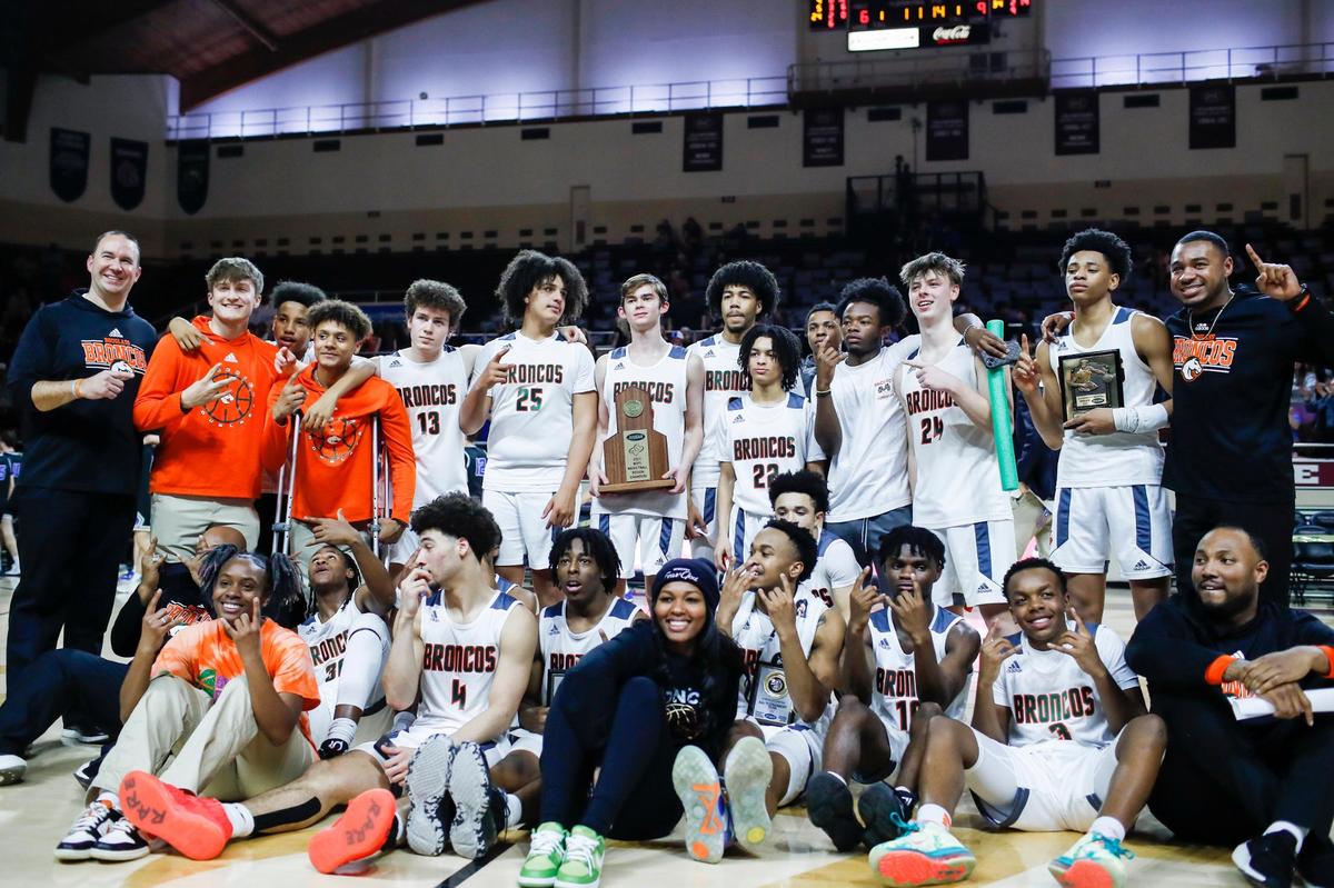 Frederick Douglass players celebrate after winning the 11th Region Tournament championship.