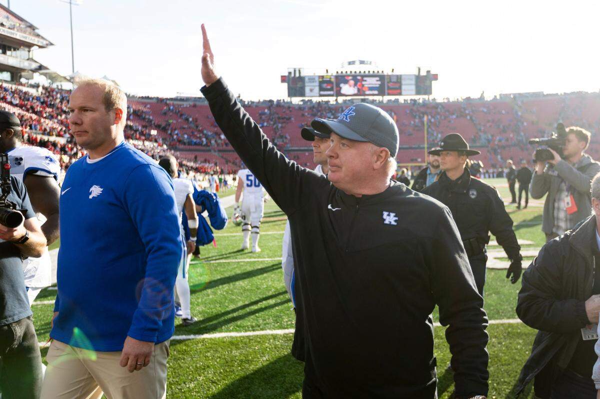 Kentucky head coach Mark Stoops celebrates after his team defeated Louisville to win the Governor’s Cup at L&N Federal Credit Union Stadium.