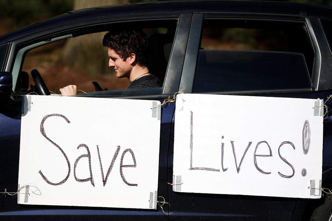 Emilio Bartlett, of Louisville, Ky., participates in a “drive-by protest” as the legislature resumes its 2020 session after a one-week break at the state Capitol in Frankfort, Ky., Thursday, March 26, 2020. The demonstration was held over fears of spreading coronavirus to lawmakers, employees and the Capitol being closed to the public.